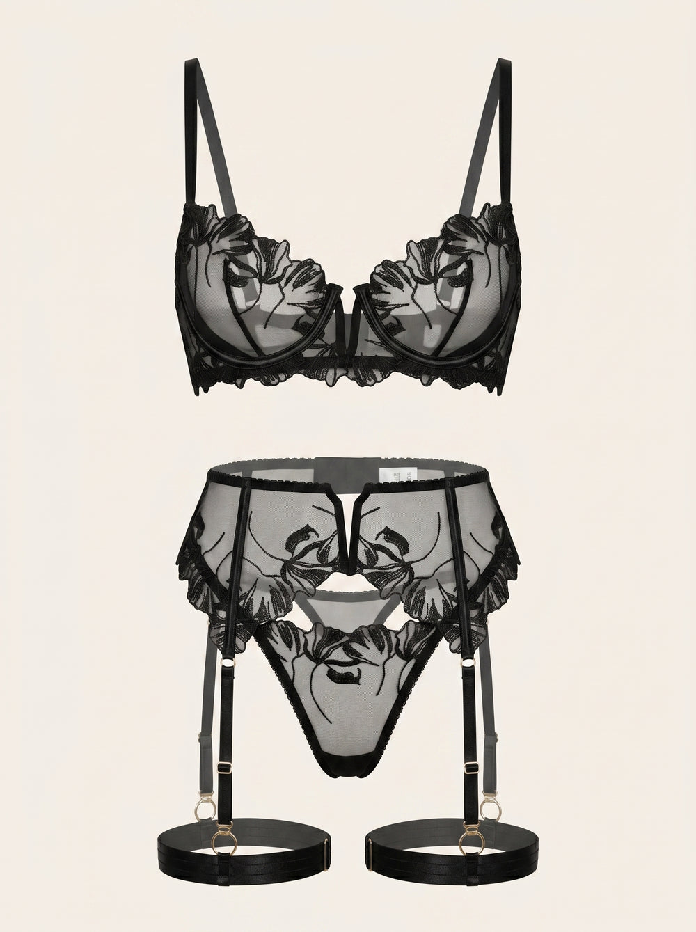Set di lingerie in rete nera con ricami floreali